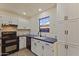 Traditional-style kitchen features white cabinetry, blue countertops, and modern appliances at 7008 W Sierra St, Peoria, AZ 85345