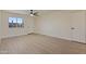 Bright living room with new flooring, ceiling fan, and a large window providing natural light at 7008 W Sierra St, Peoria, AZ 85345