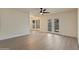 Bright living room featuring stylish new flooring and French doors to extend the space outdoors at 7008 W Sierra St, Peoria, AZ 85345