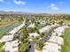 Captivating aerial view of the neighborhood featuring winding roads, lush greenery, and community tennis courts at 7832 E Via Marina --, Scottsdale, AZ 85258