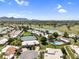 Stunning aerial view of property showcasing lush golf course, serene lake, and community amenities at 7832 E Via Marina --, Scottsdale, AZ 85258