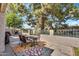 Cozy outdoor patio with table and chairs beneath a large mature tree at 7832 E Via Marina --, Scottsdale, AZ 85258