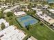 Aerial view of well-maintained tennis courts in a residential community with lush landscaping and nearby golf course at 7832 E Via Marina --, Scottsdale, AZ 85258