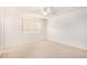 Bright bedroom featuring neutral carpet, a window with blinds, and white walls at 8501 E Malcomb Dr, Scottsdale, AZ 85250