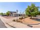 Well-maintained home featuring desert landscaping, mature trees, and a circular driveway at 8501 E Malcomb Dr, Scottsdale, AZ 85250