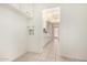 Hallway featuring a tile floor, built-in cabinets, and natural light at 8501 E Malcomb Dr, Scottsdale, AZ 85250