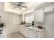 Bright kitchen with white cabinets, appliances, and a window over the double sink, offering a clean and functional space at 8501 E Malcomb Dr, Scottsdale, AZ 85250
