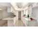 Clean, well-lit kitchen with white cabinetry, granite counters, and tile flooring at 8501 E Malcomb Dr, Scottsdale, AZ 85250