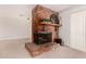 Cozy living room showcasing a rustic brick fireplace and a wooden mantel, enhancing the space's inviting charm at 8501 E Malcomb Dr, Scottsdale, AZ 85250