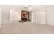 Spacious living room boasts a cozy brick fireplace, ceiling fan, and sliding glass door with bright, neutral carpet at 8501 E Malcomb Dr, Scottsdale, AZ 85250