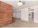 Open living area featuring a brick fireplace and access to the kitchen at 8501 E Malcomb Dr, Scottsdale, AZ 85250