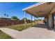 Relaxing covered patio with ceiling fan and a view of the lush, well-maintained backyard at 8501 E Malcomb Dr, Scottsdale, AZ 85250