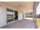 Covered patio with ceiling fans, offering a comfortable transition to the backyard and fireplace views at 8501 E Malcomb Dr, Scottsdale, AZ 85250