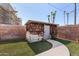 Backyard shed offering additional storage space, complemented by a well-kept lawn and landscaping at 8501 E Malcomb Dr, Scottsdale, AZ 85250