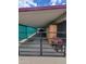 A covered carport offers ample parking and storage behind a black gate at 901 S Esperanza Ave, Mesa, AZ 85208