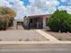 Street view of the single story home with a gate, desert landscaping and a covered carport at 901 S Esperanza Ave, Mesa, AZ 85208