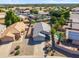 Aerial view showcasing the house, neighboring properties, desert landscaping, pool, and the surrounding area at 9422 W Monroe St, Peoria, AZ 85345
