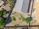 Aerial view of a backyard with partial grass, a large empty dirt patch, and block wall fence at 9422 W Monroe St, Peoria, AZ 85345