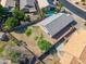 Aerial view of a backyard with partial grass, a large empty dirt patch, and block wall fence at 9422 W Monroe St, Peoria, AZ 85345