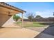 Covered patio with a ceiling fan overlooking the landscaped backyard with a concrete patio at 9422 W Monroe St, Peoria, AZ 85345