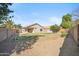 Expansive backyard featuring gravel landscaping with lush greenery, plants, and privacy block fence at 9422 W Monroe St, Peoria, AZ 85345