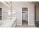 Bathroom featuring a double sink vanity, large mirror and walk-in closet at 9422 W Monroe St, Peoria, AZ 85345