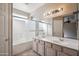 Bathroom featuring a double sink vanity and shower over tub at 9422 W Monroe St, Peoria, AZ 85345