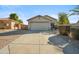 Charming single-story home featuring a spacious driveway, low-maintenance landscaping, and a two-car garage at 9422 W Monroe St, Peoria, AZ 85345