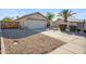 Single-story home featuring a spacious driveway, low-maintenance landscaping, and a two-car garage at 9422 W Monroe St, Peoria, AZ 85345