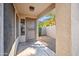 View of the front entrance with desert landscaping, a security door, and a view of the palm trees at 9422 W Monroe St, Peoria, AZ 85345