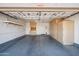 Spacious garage featuring built-in cabinets, shelving, and epoxy flooring for efficient storage and organization at 9422 W Monroe St, Peoria, AZ 85345