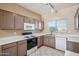 Well-lit kitchen features tile floors, a microwave, an electric range, and laminate counters at 9422 W Monroe St, Peoria, AZ 85345