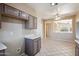 Neutral kitchen with tile floors, recessed lights, updated cabinets and a pass through window to the next room at 9422 W Monroe St, Peoria, AZ 85345