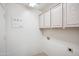 Well-lit laundry room with storage cabinets at 9422 W Monroe St, Peoria, AZ 85345