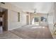 The open living room features neutral carpet, a ceiling fan, and a sliding door to the backyard at 9422 W Monroe St, Peoria, AZ 85345