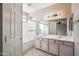 Main bathroom with double sinks, a large mirror and a shower-tub combo at 9422 W Monroe St, Peoria, AZ 85345