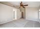 Spacious main bedroom with ceiling fan and neutral carpet at 9422 W Monroe St, Peoria, AZ 85345