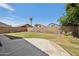 Backyard featuring block wall, grass, and trees; perfect for outdoor enjoyment and privacy at 1156 N San Benito Dr, Gilbert, AZ 85234