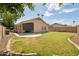 Beautifully landscaped backyard with green grass and a covered patio, perfect for outdoor entertaining at 1156 N San Benito Dr, Gilbert, AZ 85234