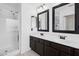 Bathroom features dual sinks, framed mirrors, and a glass shower at 1156 N San Benito Dr, Gilbert, AZ 85234