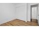 This bedroom features light, neutral walls, wood-look flooring, and a double-door closet at 1156 N San Benito Dr, Gilbert, AZ 85234