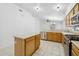 A well-lit kitchen featuring an island, ample cabinets, stainless steel appliances, and updated countertops at 1156 N San Benito Dr, Gilbert, AZ 85234