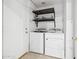 The laundry area includes a washer, dryer, shelving, and a door that leads outside at 1156 N San Benito Dr, Gilbert, AZ 85234