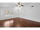 Living room with hardwood floors, ceiling fan, a chandelier, and a front door at 1156 N San Benito Dr, Gilbert, AZ 85234
