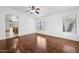 Bright living room with hardwood floors, large window, and a ceiling fan for comfortable living at 1156 N San Benito Dr, Gilbert, AZ 85234