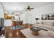 Bright living room features hardwood floors, ceiling fan, and a dining area with a chandelier at 1156 N San Benito Dr, Gilbert, AZ 85234