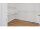 Walk-in closet with built-in shelving and hardwood floors at 1156 N San Benito Dr, Gilbert, AZ 85234