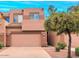 Two-story townhouse with a two-car garage, neutral tones, and desert landscaping in a well-maintained neighborhood at 1477 W Marlin Dr, Chandler, AZ 85286