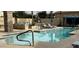 Community pool featuring lounge chairs, shade structures, and a fire pit area for residents to relax and socialize at 1477 W Marlin Dr, Chandler, AZ 85286
