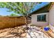 Side yard with tree, concrete slab and dirt, fully enclosed by fencing at 1509 E Verlea Dr, Tempe, AZ 85282